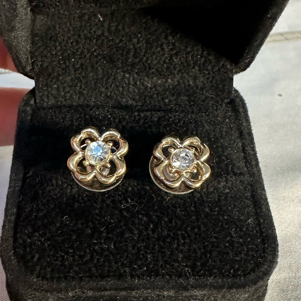 Tiny goldtone four leaf clover earrings with rhinestone center